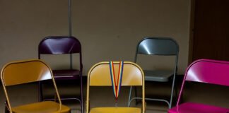 LGBTQ+ Support Groups: How They Help and Where to Find Them Empty chair circle with rainbow lanyard and scattered donuts in basement.