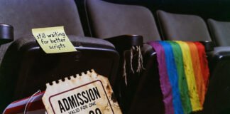 The Rise of LGBTQ+ Characters in Film: Progress or Tokenism? Cracked ticket stub in rainbow popcorn with limp Pride flag.