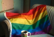 Why Community Support Is Vital for LGBTQ+ Individuals: Insights and Advice Worn rainbow flag on couch with Skittles rainbow and phone chat.